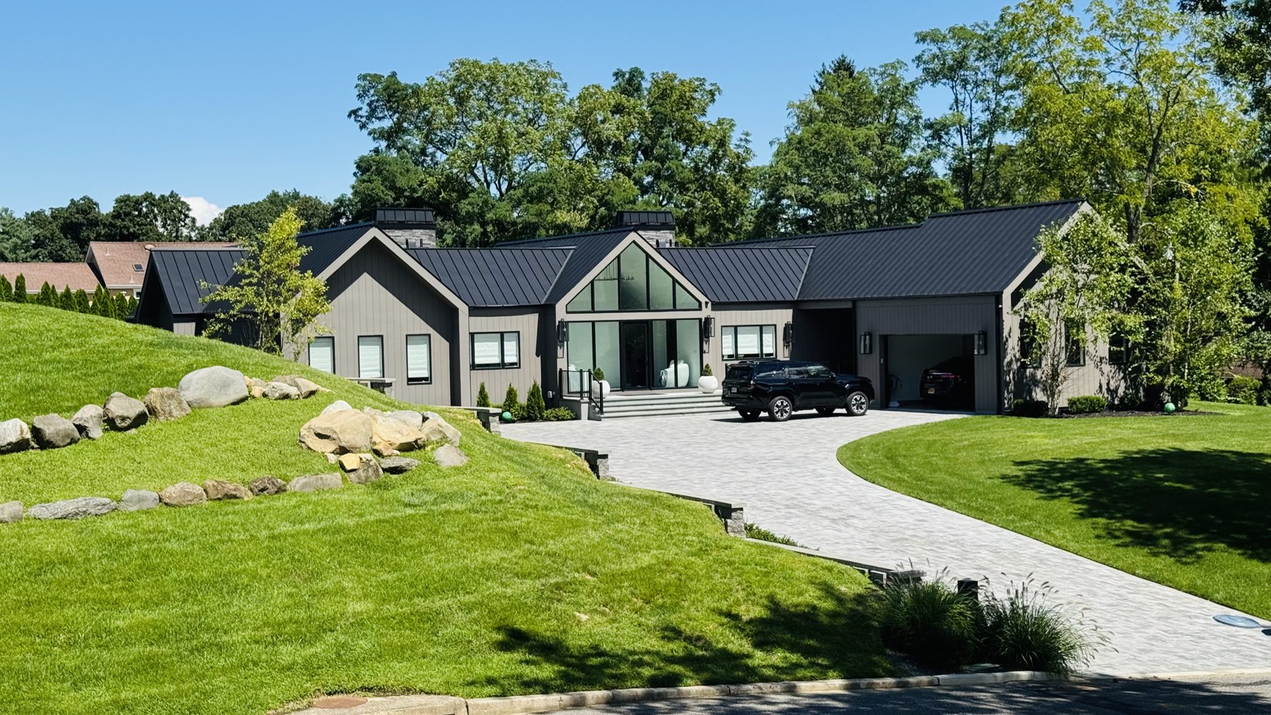 Full standing-seam black metal roof on a Suffolk County home